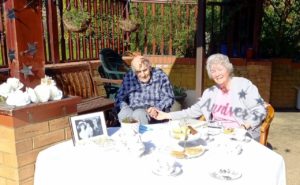 couple sitting in a garden having afternoon tea